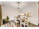 Inviting dining area featuring a wood table, stylish chairs, and modern lighting at 3827 S Fraser St, Aurora, CO 80014