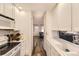 Well-lit kitchen with ample storage, neutral countertops, and a view to the living room at 3827 S Fraser St, Aurora, CO 80014