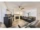 Inviting living room featuring hardwood floors, a fireplace, and large windows at 3827 S Fraser St, Aurora, CO 80014