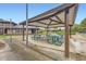 Covered picnic area with multiple green tables near well-maintained residential buildings at 3827 S Fraser St, Aurora, CO 80014