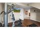 Basement workout space with multi-gym equipment and access to a finished basement area at 13979 Night Owl Ln, Parker, CO 80134