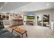 Finished basement with a bar area, entertainment center, and sliding door access to an outdoor patio at 13979 Night Owl Ln, Parker, CO 80134