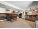 Cozy basement area with a stylish wood-paneled accent wall, wet bar, and comfortable seating at 13979 Night Owl Ln, Parker, CO 80134
