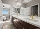 Bathroom features dual sinks, chrome fixtures, dark cabinets and tile flooring at 13979 Night Owl Ln, Parker, CO 80134