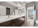 This bathroom features dual sinks, chrome fixtures, dark cabinets and tile flooring at 13979 Night Owl Ln, Parker, CO 80134