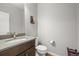 Powder room features a modern sink, toilet, and neutral wall color at 13979 Night Owl Ln, Parker, CO 80134