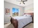 This bedroom features a ceiling fan, a window, and a dark wood bed frame at 13979 Night Owl Ln, Parker, CO 80134