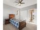 Bedroom features dark wood bed frame, nightstand, and closet with white doors at 13979 Night Owl Ln, Parker, CO 80134