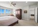Bedroom shows ceiling fan, carpet, and dark wood armoire at 13979 Night Owl Ln, Parker, CO 80134