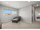 Bedroom with large windows providing natural light and seating area at 13979 Night Owl Ln, Parker, CO 80134