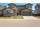 Charming two-story home with a well-maintained lawn and inviting stone accents at 13979 Night Owl Ln, Parker, CO 80134