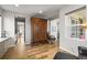 Spacious hallway showcasing wood floors and a classic decorative armoire at 13979 Night Owl Ln, Parker, CO 80134