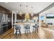 Modern kitchen boasts granite countertops, bar seating, and adjacent living area at 13979 Night Owl Ln, Parker, CO 80134
