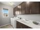 Laundry room featuring modern washer and dryer next to cabinets and a utility sink at 13979 Night Owl Ln, Parker, CO 80134