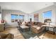 Comfortable living room bathed in natural light, with hardwood floors and a cozy sectional at 13979 Night Owl Ln, Parker, CO 80134
