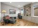 Office boasts built-in shelving, hardwood floors, and a comfortable chair at 13979 Night Owl Ln, Parker, CO 80134
