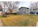 Grassy backyard space with playhouse and playset; perfect for a Gathering at 2136 S Balsam Ct, Lakewood, CO 80227