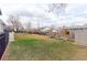 Large, landscaped backyard featuring patio, playset, and expansive grassy area for outdoor enjoyment at 2136 S Balsam Ct, Lakewood, CO 80227