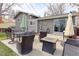 Backyard patio with table, chairs, outdoor umbrella and a fire pit perfect for relaxing at 2136 S Balsam Ct, Lakewood, CO 80227