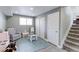 Versatile basement area with gray walls, play furniture, stairs, and a comfortable armchair at 2136 S Balsam Ct, Lakewood, CO 80227