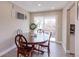 Bright dining area with a wooden table, chairs, and sliding glass door access to the backyard at 2136 S Balsam Ct, Lakewood, CO 80227