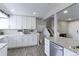 Beautiful kitchen with white cabinets, granite countertops, stainless steel appliances, and modern fixtures at 2136 S Balsam Ct, Lakewood, CO 80227