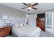 Comfortable main bedroom with ceiling fan, ensuite bathroom, and closet at 2136 S Balsam Ct, Lakewood, CO 80227