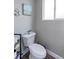 Cozy half-bathroom featuring a white toilet and nautical decor at 2136 S Balsam Ct, Lakewood, CO 80227