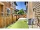 Cozy backyard featuring artificial turf, a wooden fence, and easy access to the house at 3450 Valentia St, Denver, CO 80238