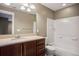 Well-lit bathroom featuring a vanity, sink, toilet, and shower/tub combo at 3450 Valentia St, Denver, CO 80238