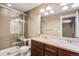 Modern bathroom features double vanity, granite countertops, and a glass shower at 3450 Valentia St, Denver, CO 80238