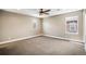 Bright, carpeted bedroom with neutral walls and a ceiling fan at 3450 Valentia St, Denver, CO 80238