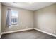 Cozy bedroom with neutral walls, carpet flooring, and large window at 3450 Valentia St, Denver, CO 80238