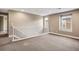 Bright, spacious bonus room featuring neutral paint, carpeting, and a white banister at 3450 Valentia St, Denver, CO 80238