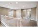 Bright, spacious bonus room featuring neutral paint, carpeting, and a white banister at 3450 Valentia St, Denver, CO 80238