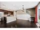 Modern kitchen features an island and stainless steel appliances, open to the living space at 3450 Valentia St, Denver, CO 80238