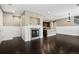 Open layout showcasing a fireplace, kitchen, and hardwood floors at 3450 Valentia St, Denver, CO 80238