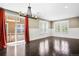 Spacious living room with sliding glass door to balcony; plantation shutters on abundant windows for natural light at 3450 Valentia St, Denver, CO 80238