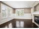 Spacious living room with bright windows, fireplace and hardwood floors at 3450 Valentia St, Denver, CO 80238