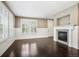 Bright living room with hardwood floors, a fireplace and white wainscoting at 3450 Valentia St, Denver, CO 80238