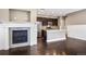 Open concept living area featuring a fireplace and hardwood floors at 3450 Valentia St, Denver, CO 80238