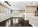 Bright living room with hardwood floors, fireplace, and large windows providing natural light; open concept at 3450 Valentia St, Denver, CO 80238