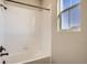 Bathroom featuring a window, white tiles, and black finishes at 14120 Bunny Hop Ln, Parker, CO 80134