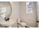 Powder bathroom with a pedestal sink, oval mirror, and tiled floor at 14120 Bunny Hop Ln, Parker, CO 80134