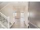 View from front door looking into entry and open floor plan, featuring hard surface floors and staircase at 14120 Bunny Hop Ln, Parker, CO 80134