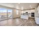 Open-concept kitchen with white cabinets, granite countertops, stainless steel appliances, and patio access at 14120 Bunny Hop Ln, Parker, CO 80134