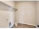 Well-lit laundry room featuring a shelf above the washer and dryer hookups, offering storage and convenience at 14120 Bunny Hop Ln, Parker, CO 80134