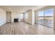 Spacious living room featuring a fireplace, large windows, and sliding glass doors to the deck at 14120 Bunny Hop Ln, Parker, CO 80134