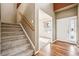 Welcoming foyer with staircase, wood floors, and access to a sunny living area at 42299 Kingsmill Cir, Elizabeth, CO 80107