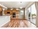 This open kitchen features wood floors, lots of cabinet space, stainless appliances and a large glass door to the outside at 42299 Kingsmill Cir, Elizabeth, CO 80107